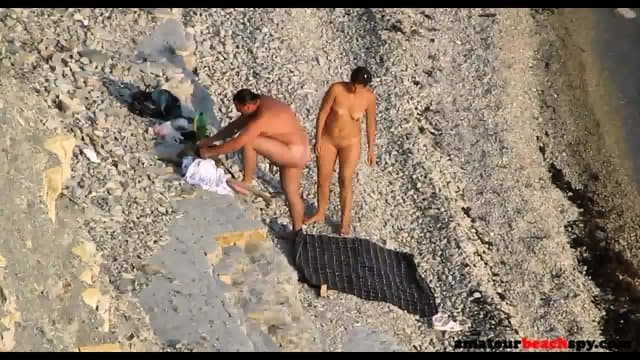Voyeur beach couple enjoying the sun