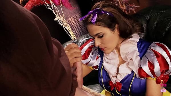 A dwarf engaged in sexual activity with Snow White, focusing on her large artificial breasts, in a vulgar and explicit manner on the sofa