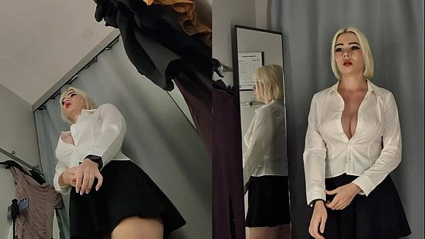 Camera in the fitting room. Trying on clothes by a beautiful blonde