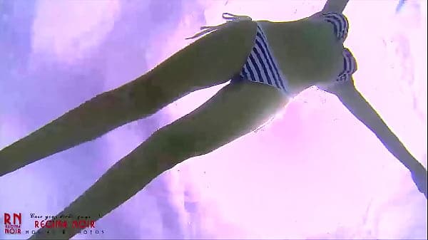 Amazing underwater bikini show. Elegant flexible babe swimming underwater in the pool