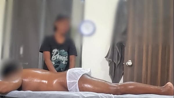 Asian spa girl massaging boy